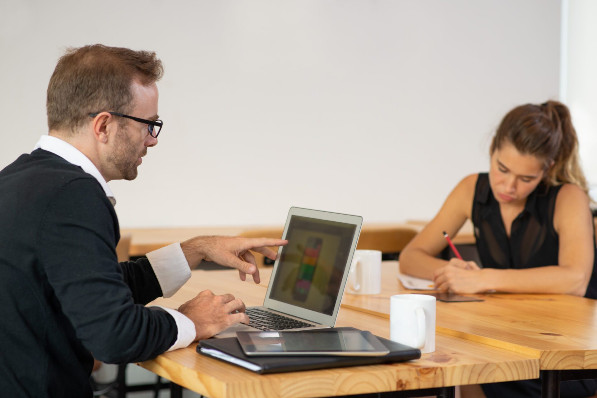 two women and one men discussing about the digital marketing